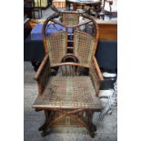 A RARE 19TH CENTURY CANE WORK BAMBOO THRONE CHAIR of unusual form. 120 cm x 60 cm.