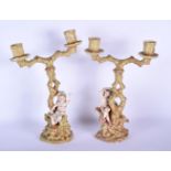 A PAIR OF ANTIQUE CONTINENTAL POTTERY CANDLESTICKS. 36 cm x 18 cm.