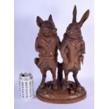 A RARE 19TH CENTURY BLACK FOREST CARVED TOBACCO JAR IN THE FORM OF A STANDING FOX AND HARE modelled