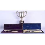 A VINTAGE SILVER TROPHY together with two plated cutlery. Silver 290 grams. Largest 18 cm x 18 cm. (