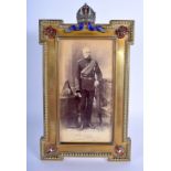 A FINE 19TH/20TH CENTURY EUROPEAN ENAMELLED MILITARY GILT METAL PHOTOGRAPH FRAME formed with a gem s