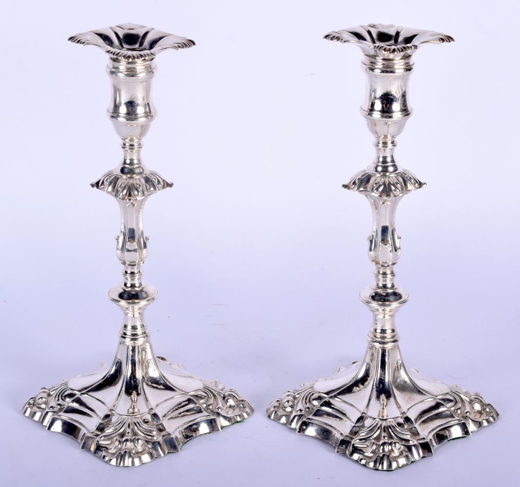 A MATCHED PAIR OF ENGLISH SILVER CANDLESTICKS. London 1761 & 1755. 1462 grams. 25 cm high.