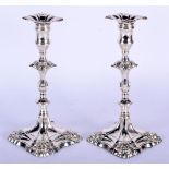 A MATCHED PAIR OF ENGLISH SILVER CANDLESTICKS. London 1761 & 1755. 1462 grams. 25 cm high.