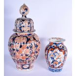 A LARGE 19TH CENTURY JAPANESE MEIJI PERIOD RIBBED VASE AND COVER together with a smaller imari vase.