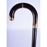 AN ANTIQUE 18CT GOLD GARANTI SLENDER WALKING CANE. 88 cm long.