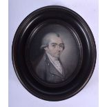 A GEORGE III PAINTED IVORY PORTRAIT MINIATURE depicting a man wearing a ruffled coat. Image 7 cm x 5