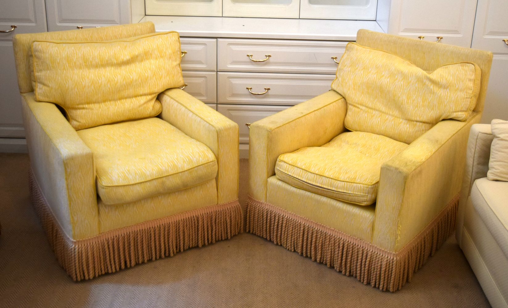 A PAIR OF DEEP COUNTRY HOUSE STYLE YELLOW ARM CHAIRS with associated gypsy table. (3)