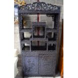 A LARGE 19TH CENTURY CHINESE HONGMU DISPLAY CABINET ON STAND Qing, decorated with foliage and vines.