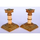 A PAIR OF MID 19TH CENTURY FRENCH IVORY AND BRONZE CANDLESTICKS of Corinthian column form. 12 cm hig