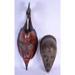 AN AFRICAN TRIBAL IVORY COAST GURO MASK together with another tribal hardwood mask. Largest 60 cm lo
