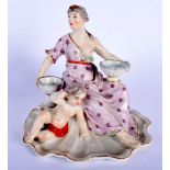A 19TH CENTURY EUROPEAN PORCELAIN FIGURE OF A FEMALE modelled holding two bowls upon a shell. 20 cm