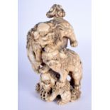 A FINE 19TH CENTURY JAPANESE MEIJI PERIOD CARVED IVORY OKIMONO modelled as Buddhistic lions in vario