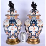 A PAIR OF 19TH CENTURY JAPANESE MEIJI PERIOD IMARI VASES AND COVERS painted in the Edo Period style,