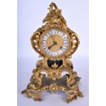 A 19TH CENTURY FRENCH ORMOLU SCROLLING MANTEL CLOCK with grotesque fish mounts, embellished in folia