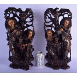 A RARE PAIR OF 19TH CENTURY CHINESE SILVER INLAID HARDWOOD FIGURAL GROUPS modelled pouring tea upon