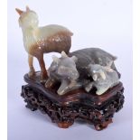 A FINE EARLY 20TH CENTURY CHINESE CARVED THREE COLOUR JADE GROUP depicting rams upon a well carved h