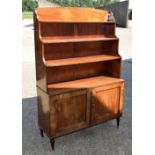 A REGENCY MAHOGANY WATERFALL BOOKCASE with geometric square form doors and tapering shelves. 162 cm