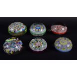 SIX EUROPEAN MILLIFIORE GLASS PAPERWEIGHTS of various designs and sizes. Largest 7.5 cm wide. (6)