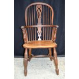 A 19th century wooden Windsor chair. 104 x 49cm