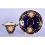 Kerr and Binns Worcester two handled cup and saucer painted with classical busts with gilt swags on