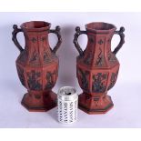 A PAIR OF 19TH CENTURY TWIN HANDLED ANTIQUITY REVIVAL POTTERY VASES stamped FG moulded with figures.