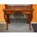 A MID 19TH CENTURY CONTINENTAL CARVED BURR WALNUT FOLDING CARD TABLE overlaid with foliage and vines