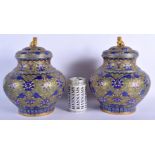 A LARGE PAIR OF EARLY 20TH CENTURY CHINESE CLOISONNE ENAMEL JARS AND COVERS overlaid with foliage an