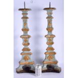 A LARGE PAIR OF 19TH CENTURY EUROPEAN BLUE AND GILT PAINTED WOOD PRICKET CANDLESTICKS upon triangula