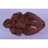 AN 18TH CENTURY FRENCH CARVED COQUILLA NUT SNUFF BOX modelled as a male holding a cup. 8 cm x 4.5 cm