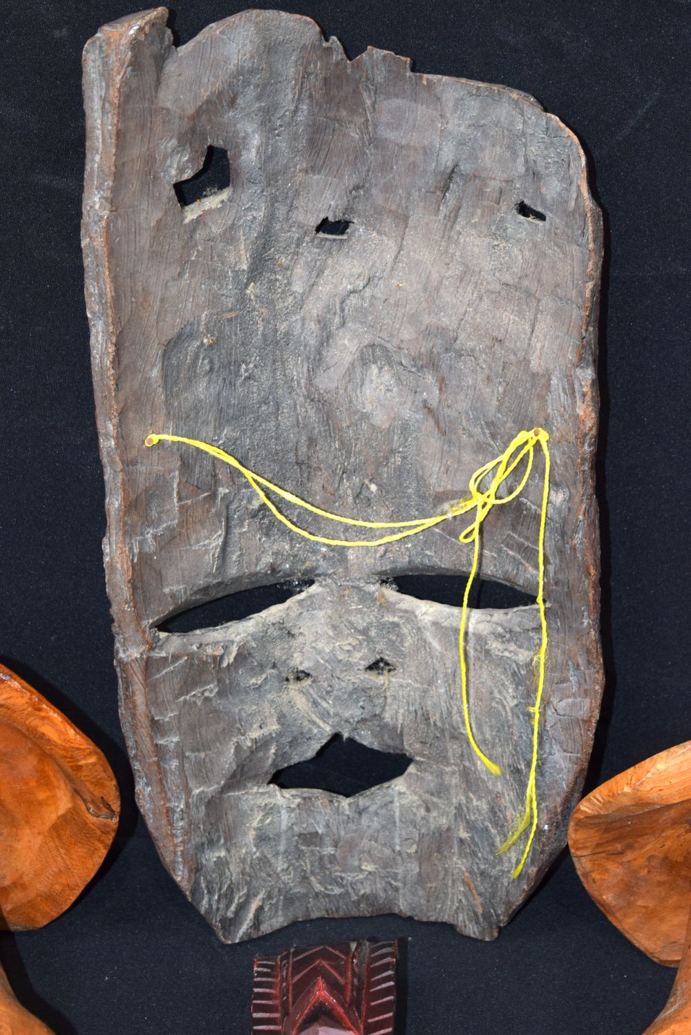 A large carved hardwood African mask, together with two carved wooden mushrooms and a small wooden t - Image 8 of 9