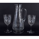 AN ANTIQUE EUROPEAN ENGRAVED GLASS JUG with matching glasses. Largest 28 cm high. (3)