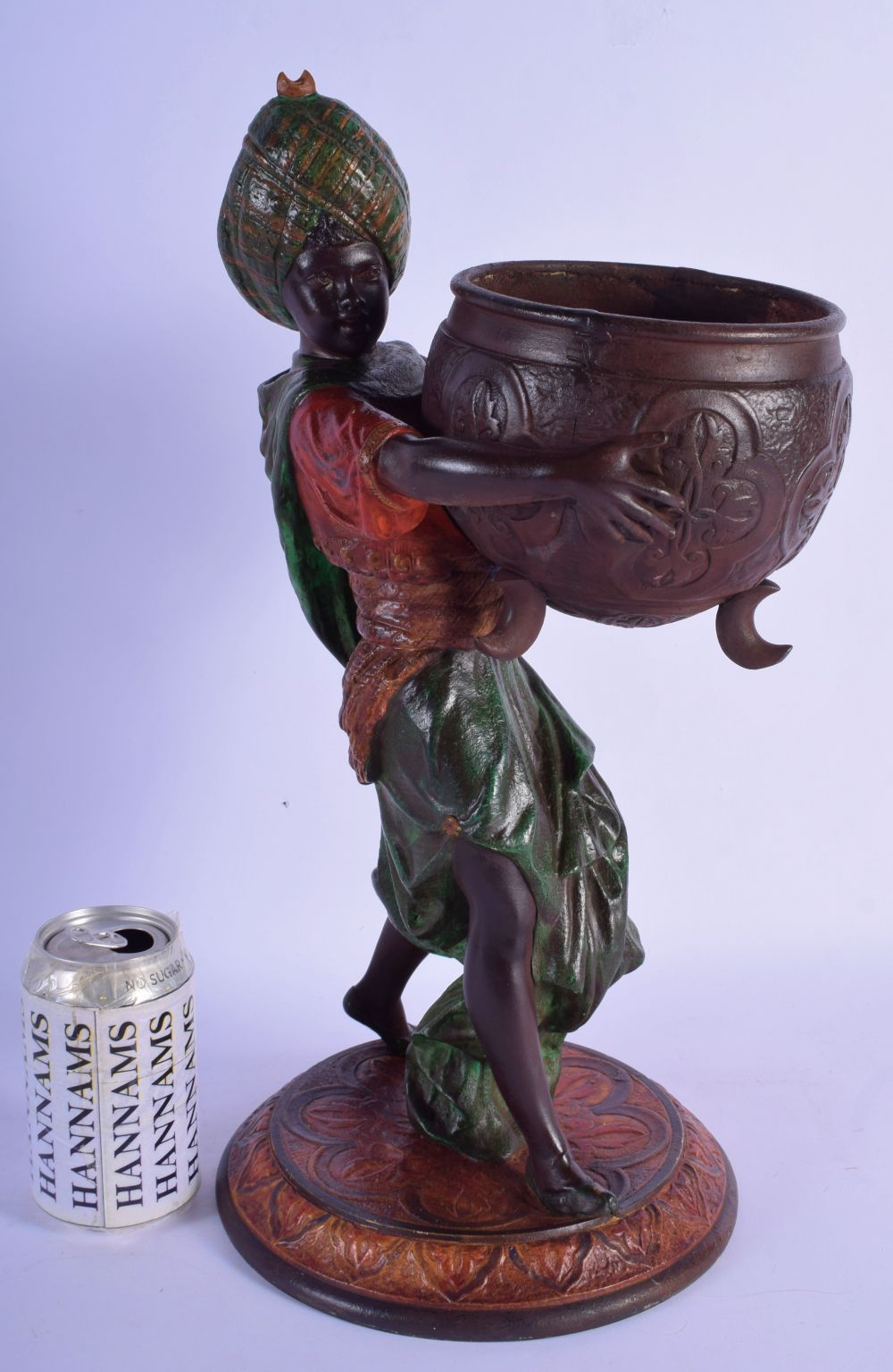 A 19TH CENTURY EUROPEAN PAINTED SPELTER FIGURE OF A MALE modelled wearing a turban holding a censer.
