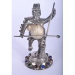 A CHARMING VICTORIAN SILVER GEM SET FIGURE OF A DANCING MALE inset with a shell, upon a naturalistic