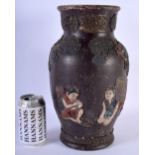 A 19TH CENTURY JAPANESE MEIJI PERIOD PAINTED TERRACOTTA VASE decorated in relief with figures and tr