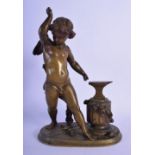 AN ANTIQUE EUROPEAN BRONZE FIGURE OF A STANDING CHERUB modelled at work beside an anvil. 24 cm x 12