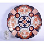 A 19TH CENTURY JAPANESE MEIJI PERIOD IMARI SCALLOPED PLATE painted with flowers. 35 cm wide.