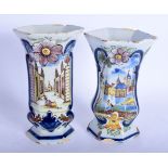 A PAIR OF 19TH CENTURY DUTCH DELFT FAIENCE TIN GLAZE VASES painted with European scenes. 23.5 cm hig