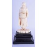 AN UNUSUAL 19TH CENTURY ANGLO INDIAN CARVED IVORY FIGURE OF A BUDDHISTIC MALE modelled holding a pla