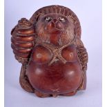 A JAPANESE CARVED WOOD FIGURE OF A BEAR modelled holding a rope. 11 cm x 7 cm.