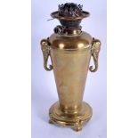 A 19TH CENTURY FRANCO JAPANESE TWIN HANDLED BRONZE OIL LAMP with elephant mask head handles. 38 cm h