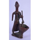 AN UNUSUAL EARLY 20TH CENTURY EUROPEAN BRONZE FIGURE OF A STANDING FEMALE modelled stirring a bowl.