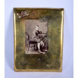 AN ARTS AND CRAFTS BRASS AND AGATE PHOTOGRAPH FRAME decorated with insects and birds. 27 cm x 19 cm.