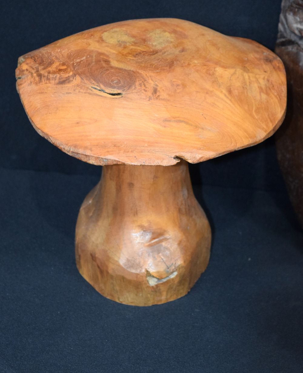 A large carved hardwood African mask, together with two carved wooden mushrooms and a small wooden t - Image 2 of 9