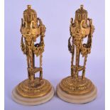 A PAIR OF LATE 18TH CENTURY EUROPEAN ORMOLU MANTEL STICKS formed with unusual mask heads and draped
