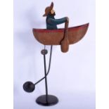 A CHARMING FOLK ART PAINTED METAL AUTOMATON TYPE SWINGING ROWING BOAT. 45 cm x 22 cm.