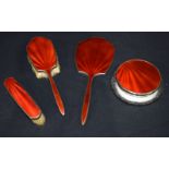 An antique dressing table set with a red lacquer backing. 27cm (4)