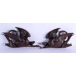 A PAIR OF 18TH/19TH CENTURY ITALIAN CARVED WOOD MYTHICAL BIRDS modelled scowling. 30 cm x 14 cm.