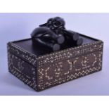 A RARE 19TH CENTURY ANGLO INDIAN EBONY AND IVORY CASKET unusually modelled with an elephant upon a r