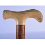 AN EARLY 19TH CENTURY CONTINENTAL CARVED IVORY HANDLED WALKING CANE with boar head terminal. 90 cm l