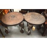 A PAIR OF 19TH CENTURY ANGLO INDIAN CARVED WOOD ELEPHANT HEAD COUNTRY HOUSE TABLES decorated with Bu